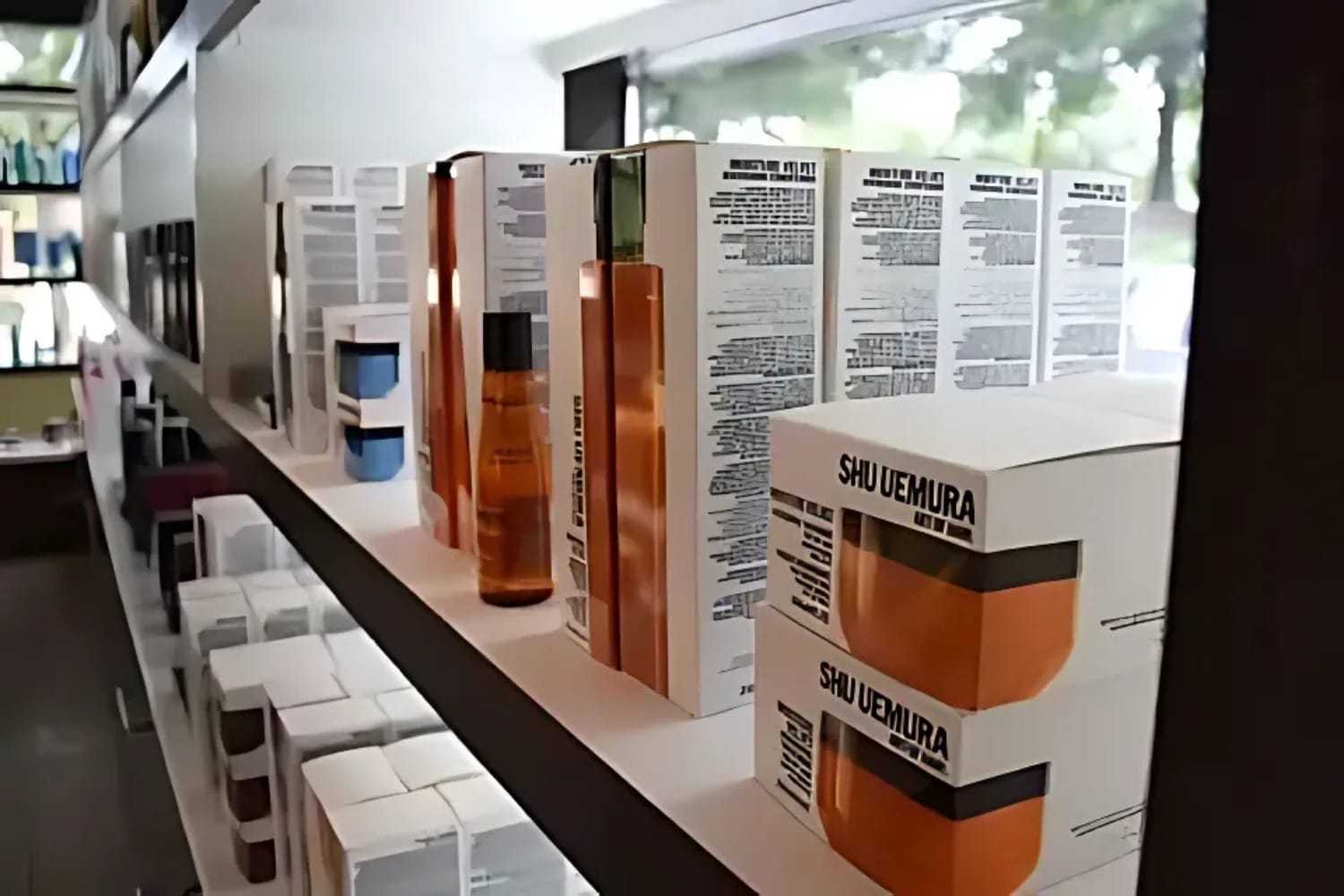 Shelves displaying various Shu Uemura haircare products in a store setting.