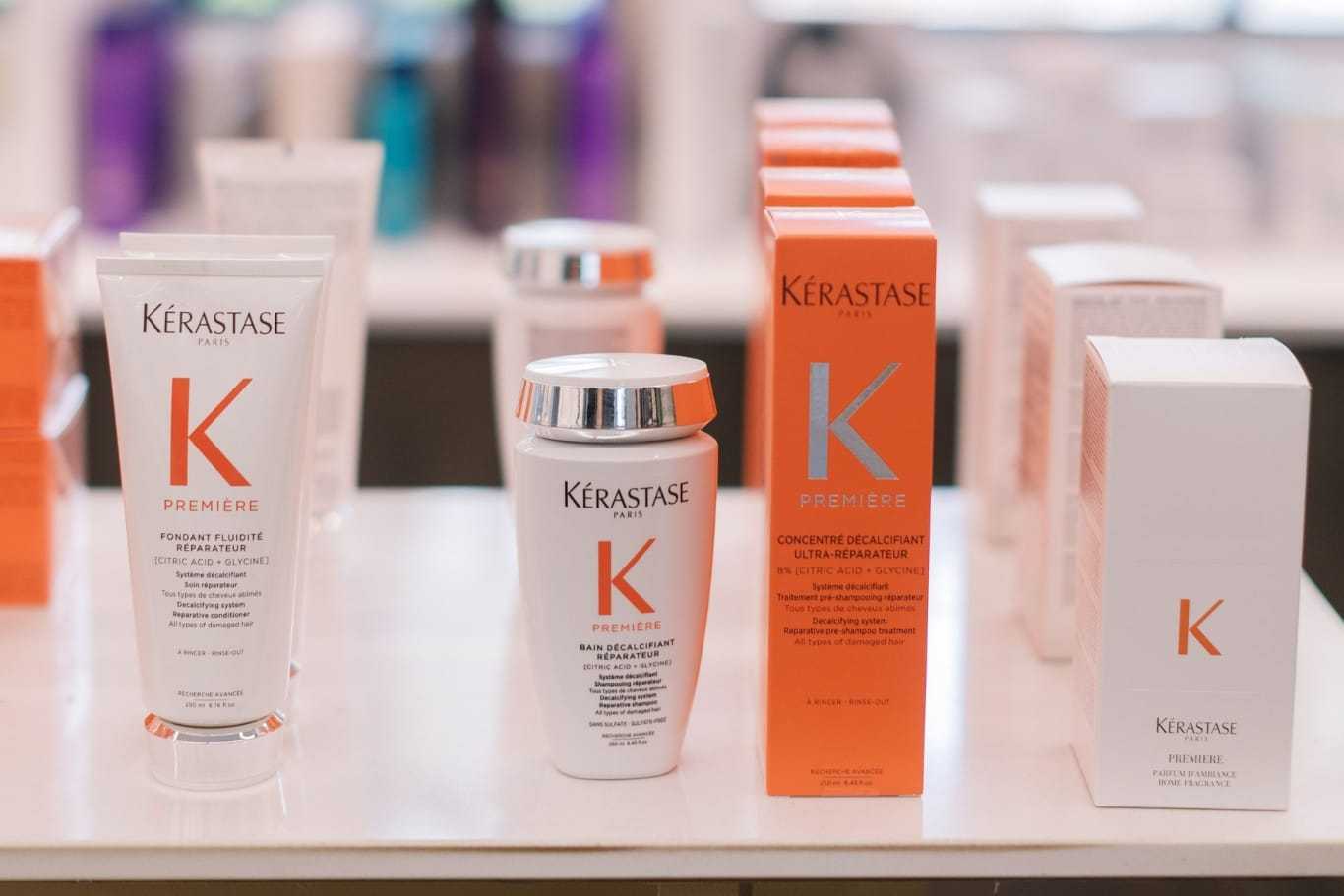 Hair care products from Kérastase displayed on a shelf.